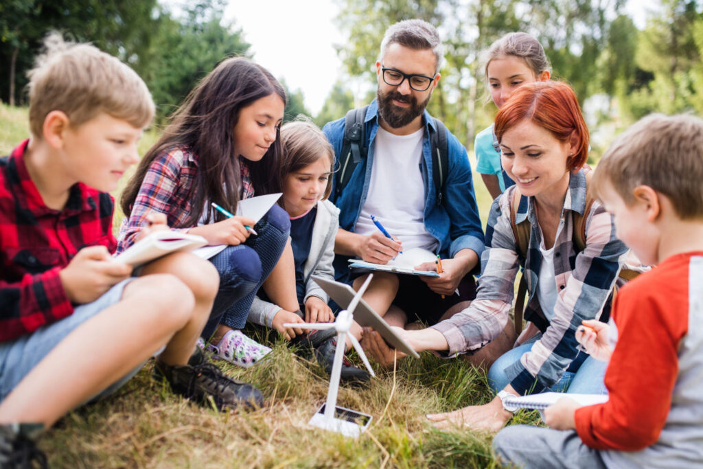 Group,of,school,children,with,teacher,and,windmill,model,on